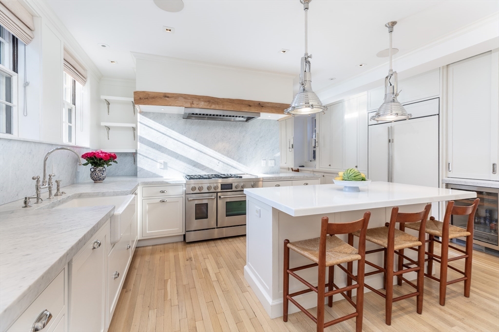 62 Beacon Street, Unit 3 Boston, MA 02108 - Photo 8 of 25 a kitchen with a table chairs sink and cabinets
