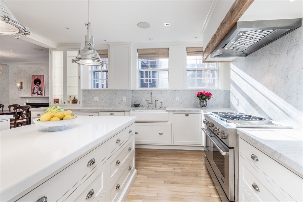 62 Beacon Street, Unit 3 Boston, MA 02108 - Photo 9 of 25 a kitchen with a sink stove and cabinets
