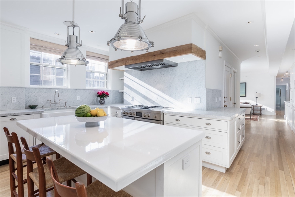 62 Beacon Street, Unit 3 Boston, MA 02108 - Photo 10 of 25 a kitchen with sink cabinets and wooden floor