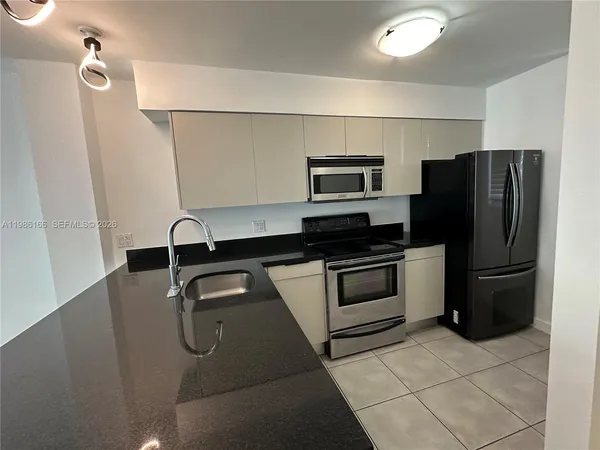 a kitchen with a refrigerator and a sink