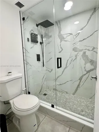 a bathroom with a toilet and a shower