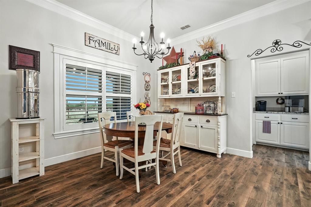 136 Dove Run Tuscola, TX 79562 - Photo 15 of 36 Dining room featuring crown molding, dark wood style floors, and a chandelier