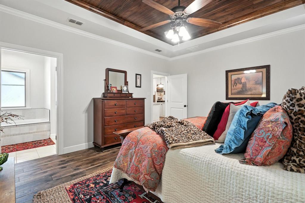 136 Dove Run Tuscola, TX 79562 - Photo 18 of 36 Bedroom featuring wooden ceiling, crown molding, dark wood-type flooring, and ceiling fan