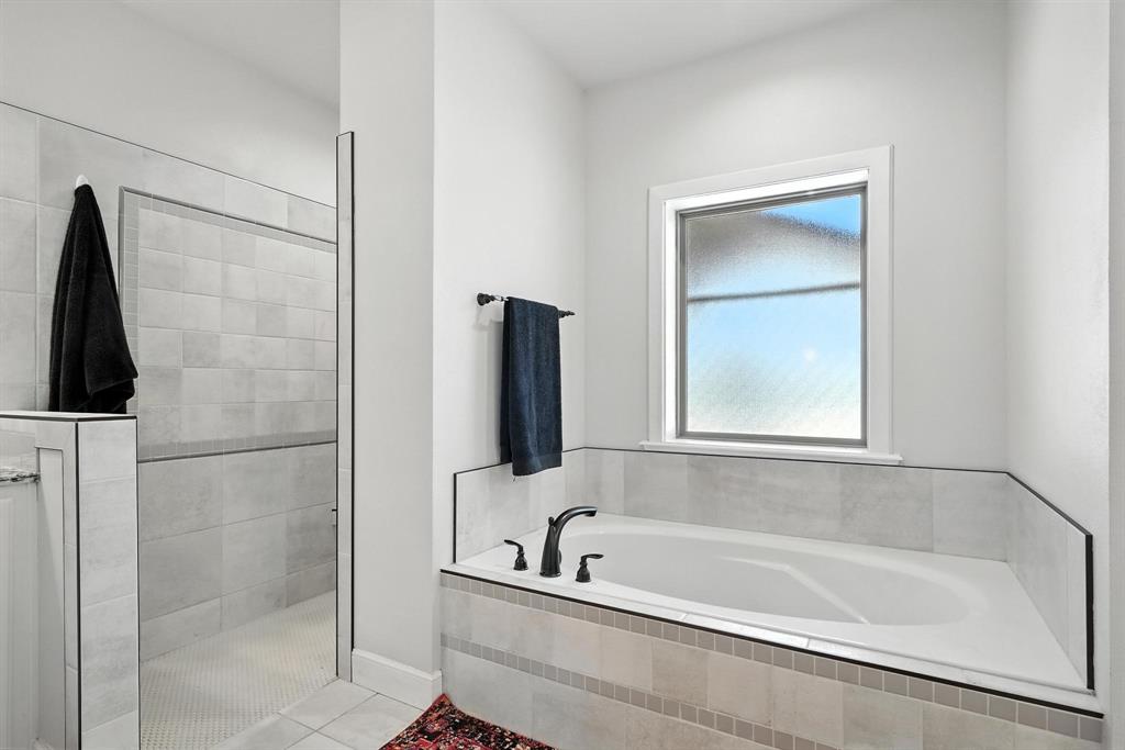 136 Dove Run Tuscola, TX 79562 - Photo 19 of 36 Full bathroom with garden tub, a tile shower, and tile flooring