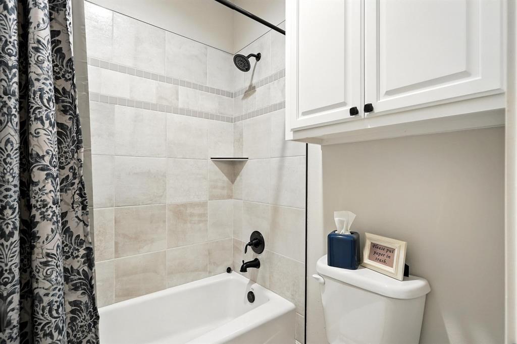 136 Dove Run Tuscola, TX 79562 - Photo 29 of 37 Bathroom with shower/tub combo with curtain and toilet