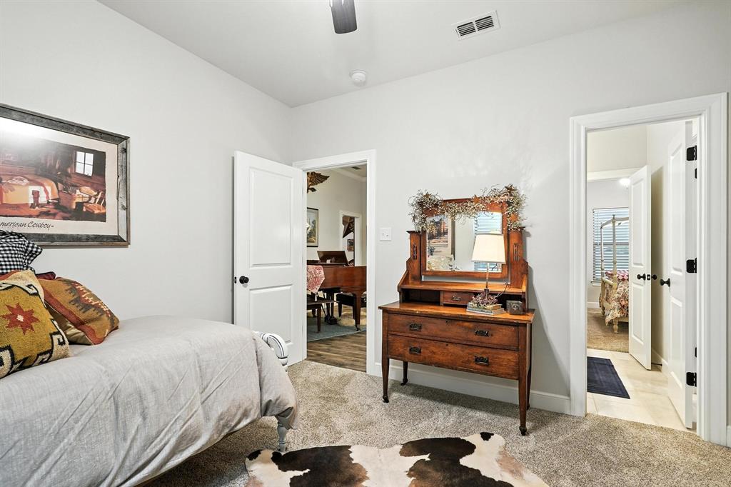 136 Dove Run Tuscola, TX 79562 - Photo 30 of 37 Bedroom featuring light carpet and a ceiling fan