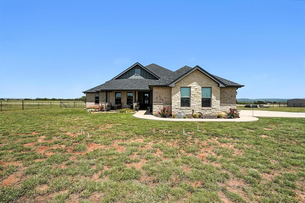 136 Dove Run Tuscola, TX 79562 - Photo 36 of 37 Front of home with stone siding, a shingled roof, and brick siding