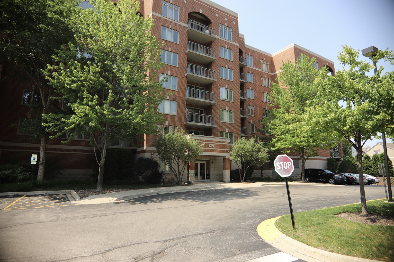 390 Western Avenue, Unit 308 Des Plaines, IL 60016 - Photo 1 of 17 a front view of a building with garden