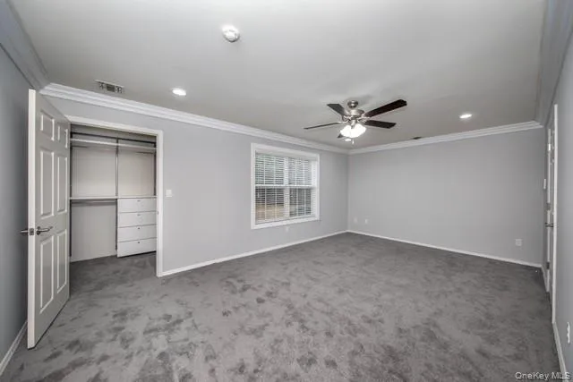 a view of an empty room with a ceiling fan