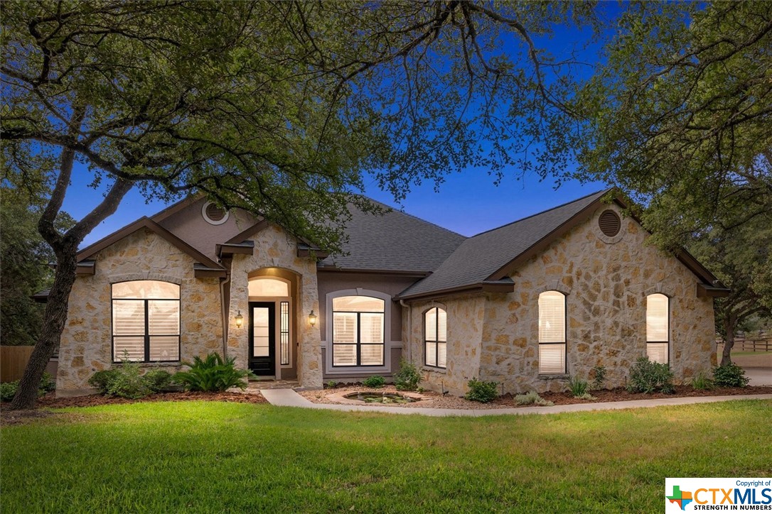 a front view of a house with a yard