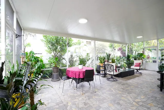 a view of a room with furniture and a large window