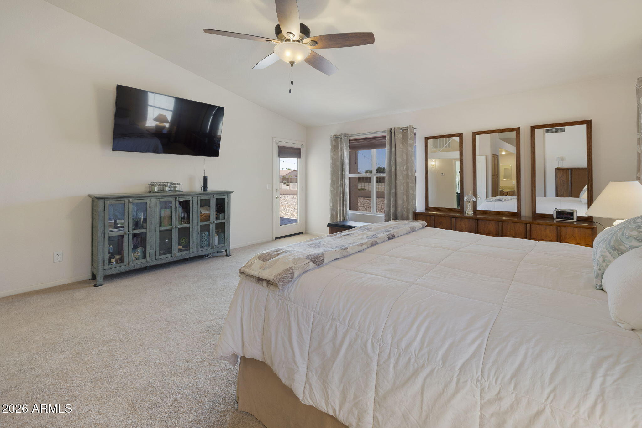 12435 West Monte Vista Road Avondale, AZ 85392 - Photo 35 of 69 a bedroom with a bed and a flat screen tv