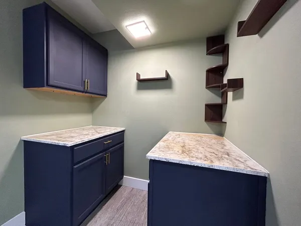 a kitchen with a stove refrigerator and microwave