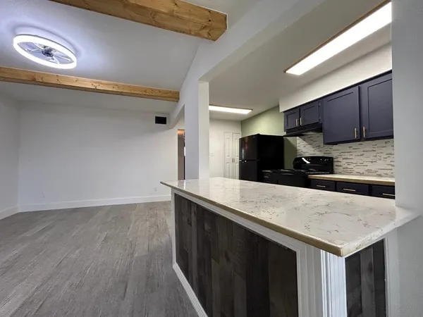 a kitchen with a sink a microwave and cabinets