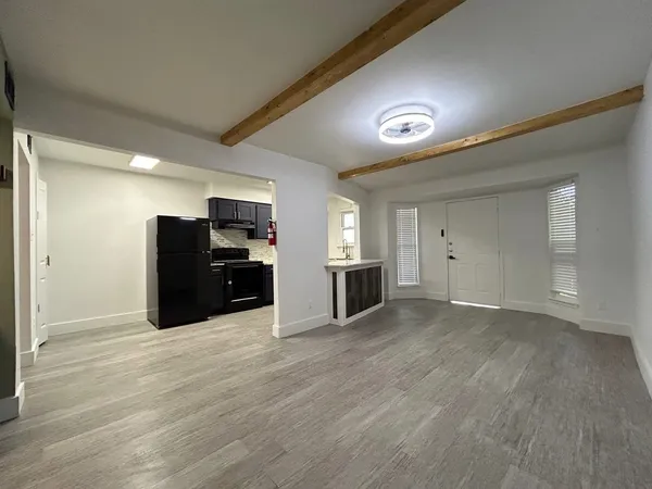 a view of kitchen with furniture and refrigerator