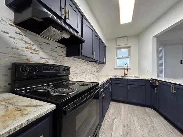 a kitchen with a stove and a sink