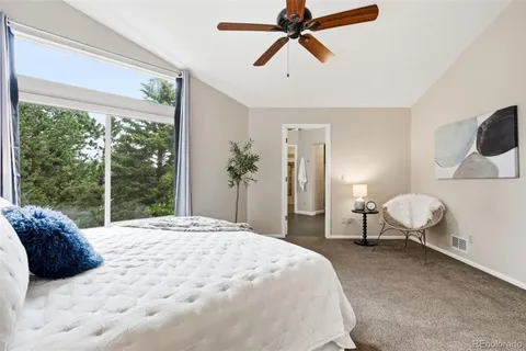 a bedroom with a bed couch and window