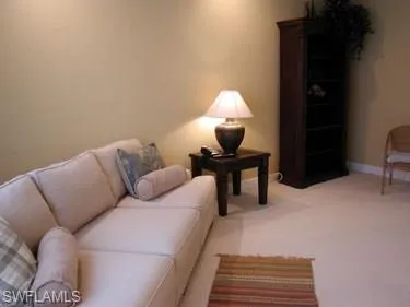 a living room with furniture and a lamp