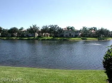 a view of a lake with houses in the back