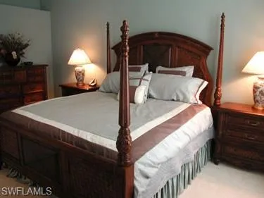 a bed room with a bed and a lamp