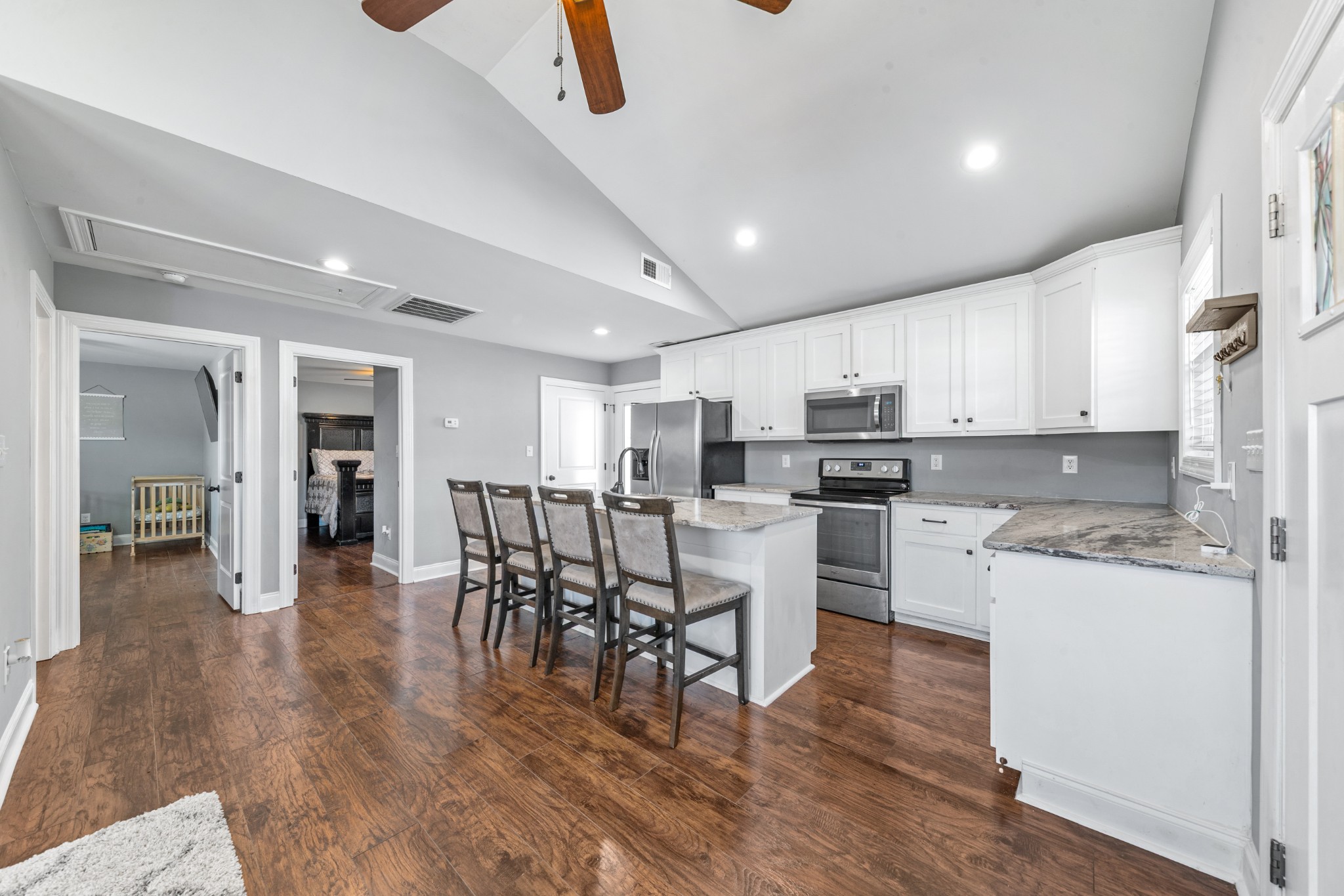 807 Clear Creek Road Pulaski, TN 38478 - Photo 14 of 68 a kitchen with stainless steel appliances granite countertop a refrigerator a stove top oven a sink dishwasher and white cabinets with wooden floor