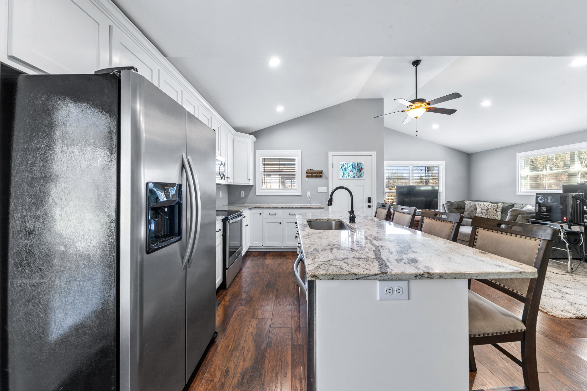 807 Clear Creek Road Pulaski, TN 38478 - Photo 20 of 68 a kitchen with stainless steel appliances granite countertop a refrigerator a sink dishwasher a stove and a dining table with wooden floor