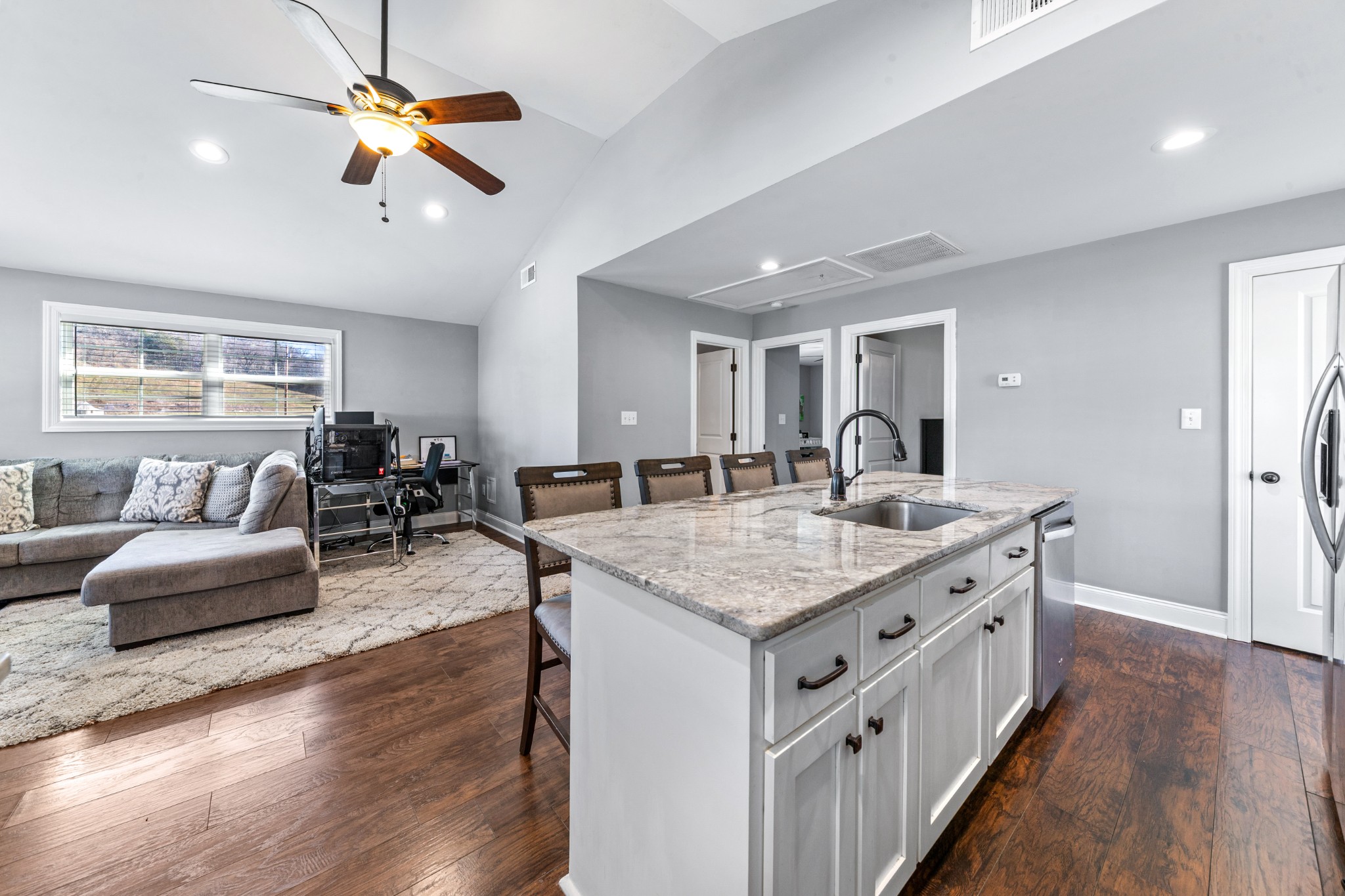 807 Clear Creek Road Pulaski, TN 38478 - Photo 23 of 68 a kitchen with stainless steel appliances granite countertop a stove oven a dining table and chairs with wooden floor