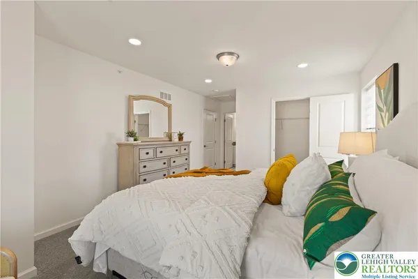 a bedroom with a bed and a couch