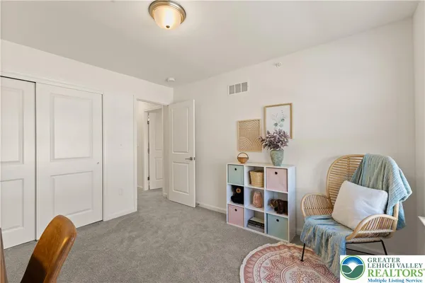 a living room with furniture and a chair