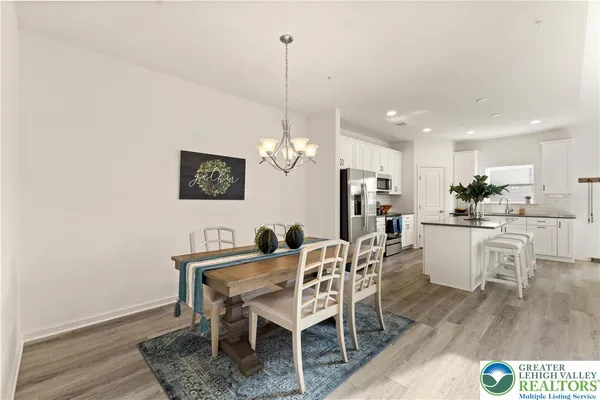 a view of a dining room with furniture and wooden floor