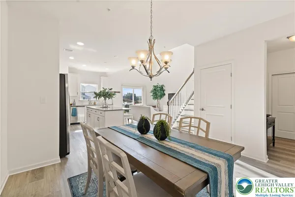 a room with table chairs and wooden floor