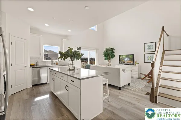 a kitchen with white cabinets and sink