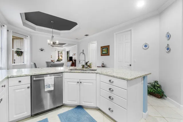 a bedroom with a bed and a lamp on dresser