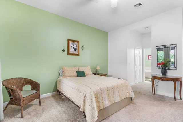 a bedroom with a bed and a large window