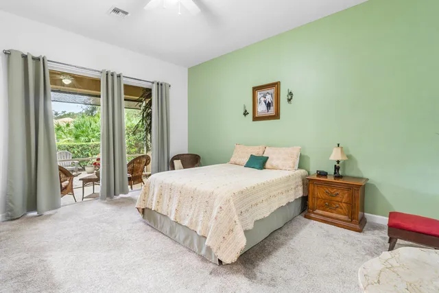 a living room with furniture a flat screen tv and a large window