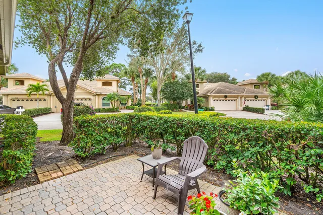 an aerial view of a house with yard and lake view