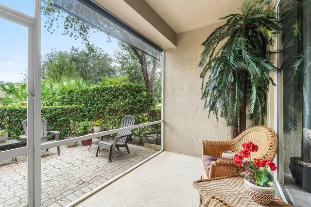 a living room with furniture a rug and a book shelf