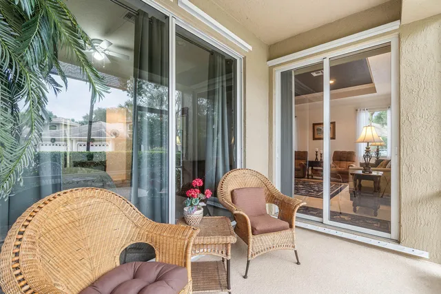 a living room with lots of furniture a rug a table and chairs