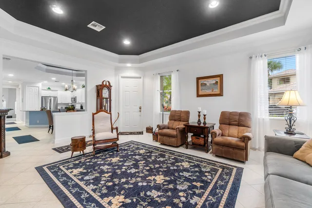 a kitchen with stainless steel appliances granite countertop white cabinets a sink a stove a microwave and wooden floors