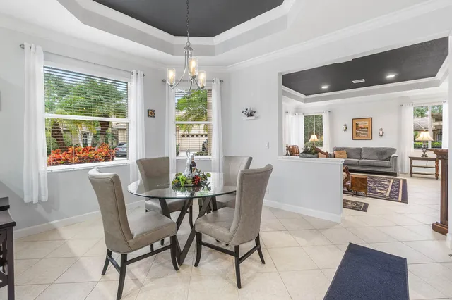 a large white kitchen with stainless steel appliances granite countertop a stove and a sink