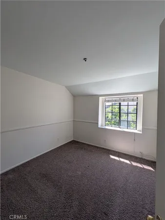 an empty room with a empty space and windows