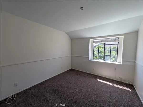 an empty room with a empty space and windows