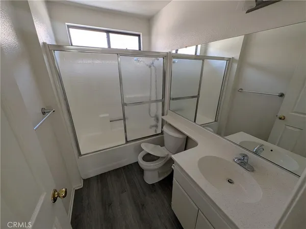 a bathroom with a sink and mirror with toilet