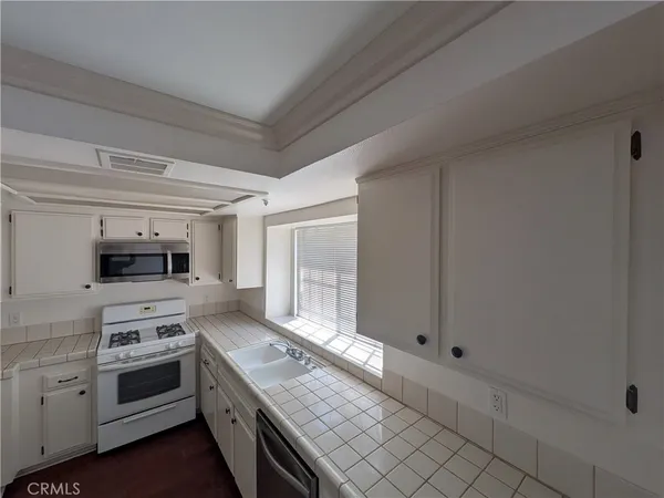 a kitchen with a stove and a refrigerator