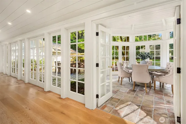 a view of a livingroom with wooden floor and furniture