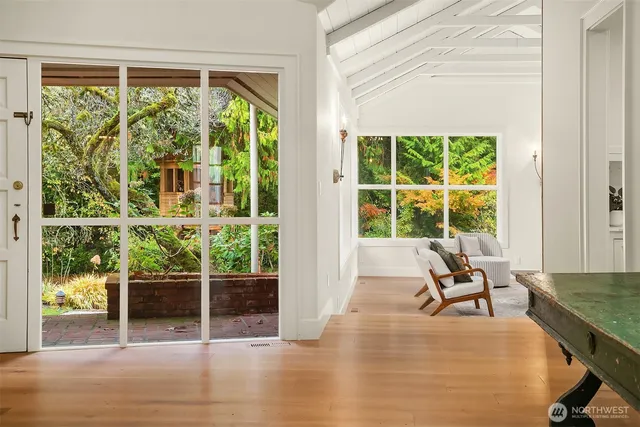 a view of a room with wooden floor and windows