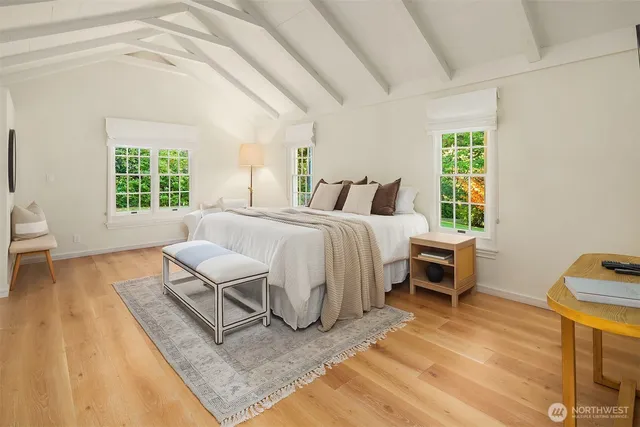 a spacious bedroom with a bed and a window