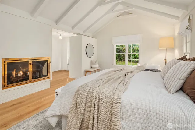 a bedroom with a bed and a fireplace