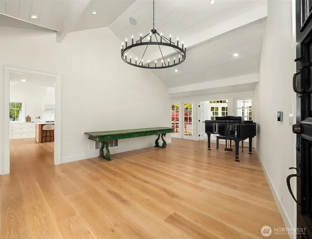 a living room with furniture a table flowerpot and a chandelier