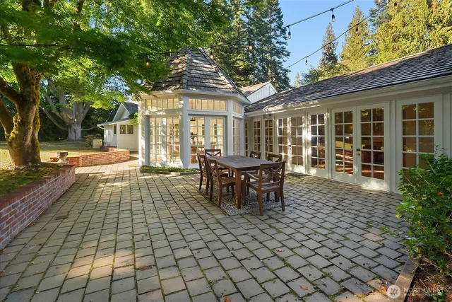 a view of a patio with table and chairs and potted plants